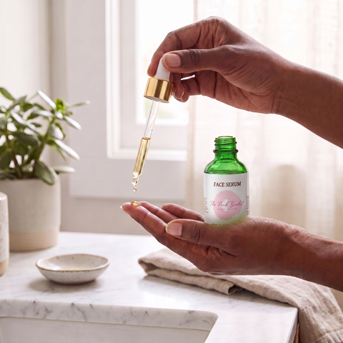 Applying Face Serum with the open bottle, labeled, and glass dropper pipette, lifestyle photo